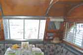 Photo of spacious upholstered dining room seating in 1947 Aero Flite Trailer